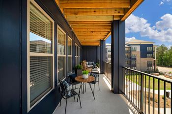 A patio with a table and chairs and a wooden roof